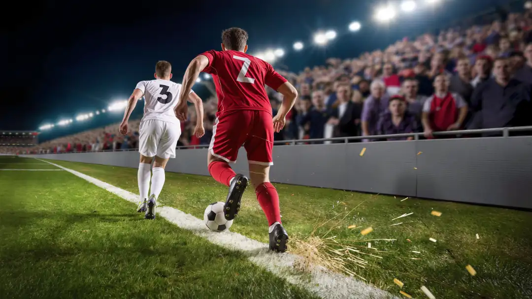 winger in red sprinting down the touchline at night