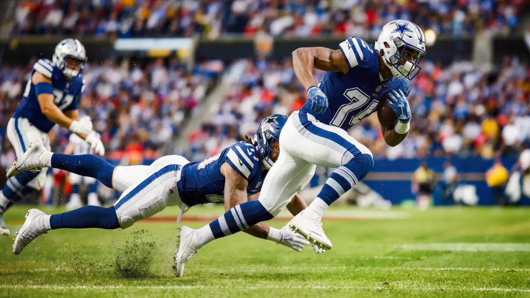 Star running back cutting upfield at full speed under primetime lights
