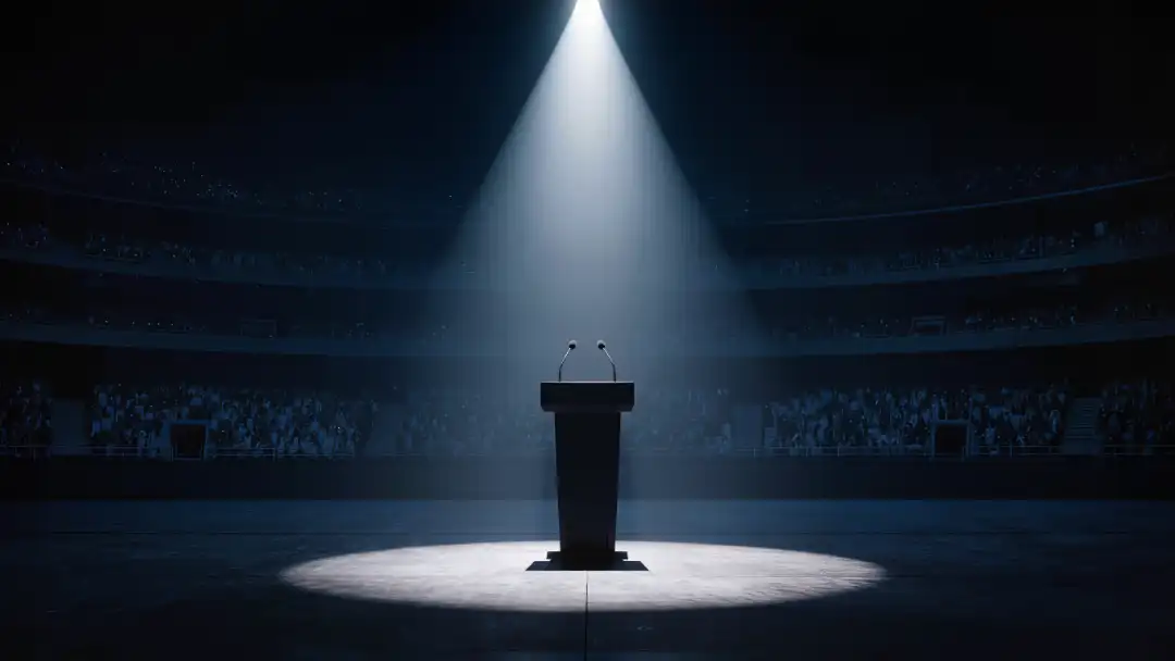 Empty draft-night podium in a single spotlight on a dark stage