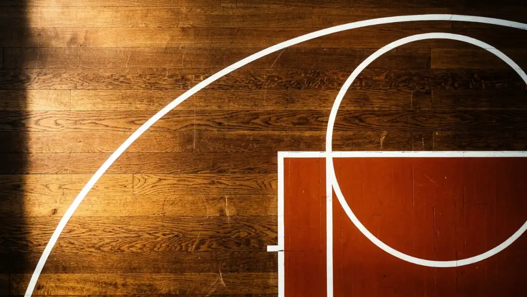 Top-down view of basketball court lines forming bold geometry