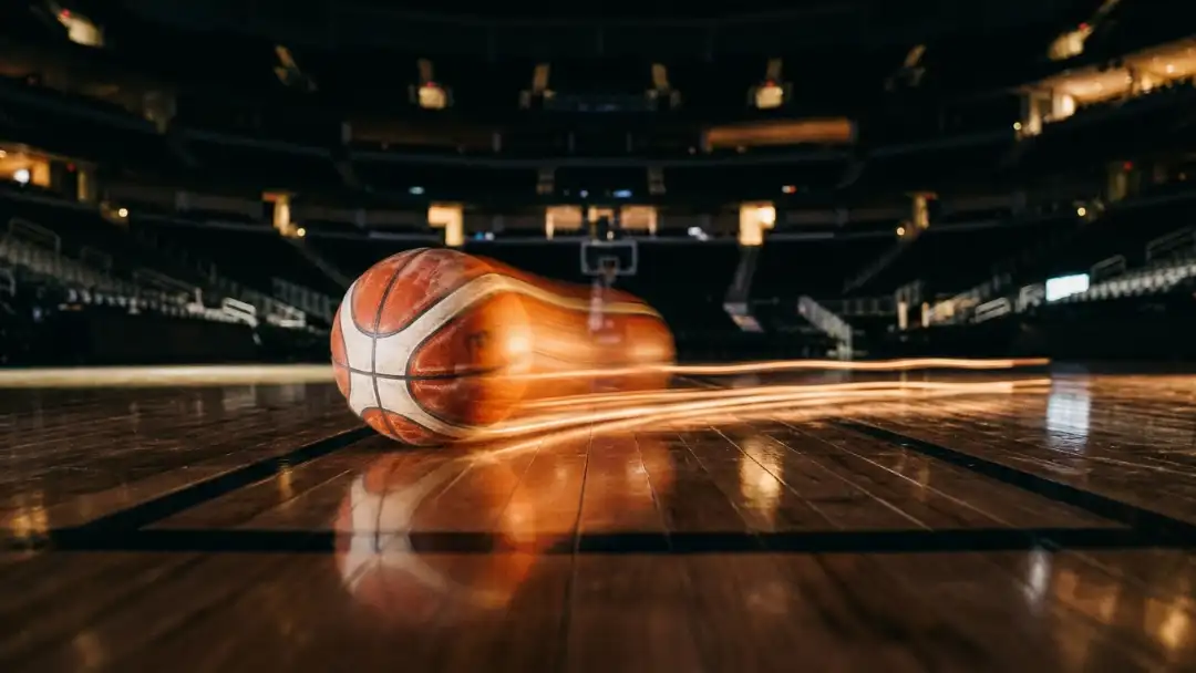 Motion-blurred basketball rolling across hardwood