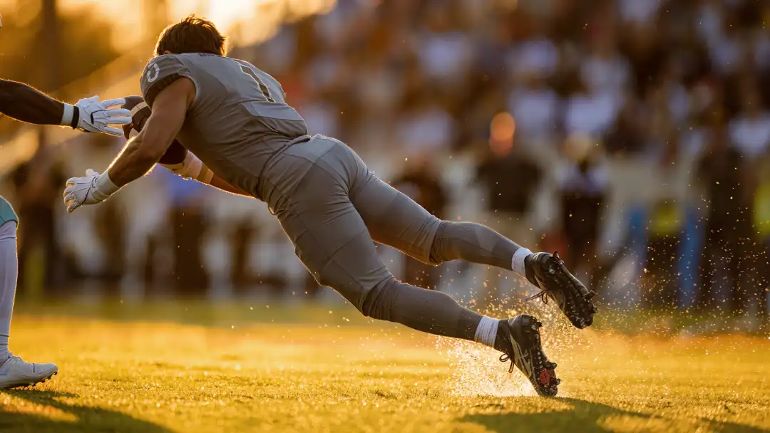 Receiver catching a short pass and spinning away from a tackler