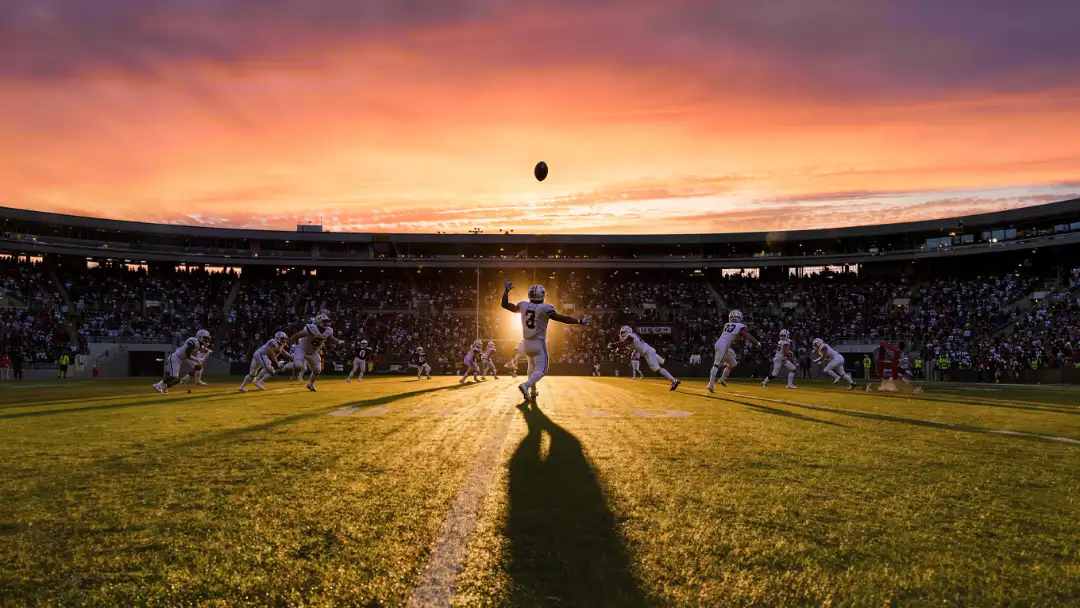 quarterback launching a deep pass at golden hour