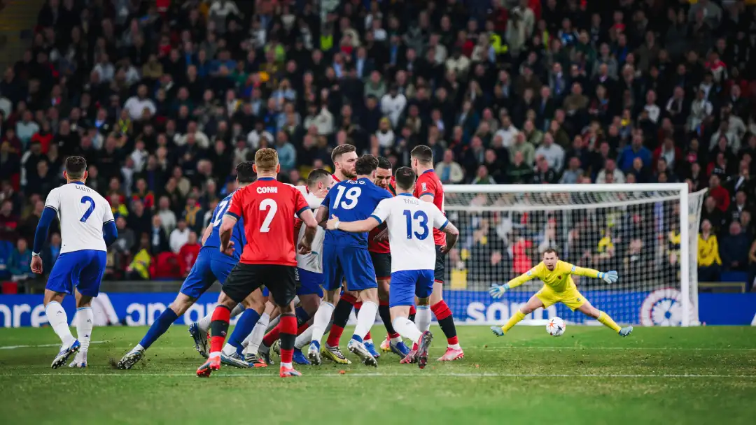 crowded six-yard box as players rise for a near-post header