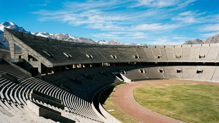 Vast historic concrete stadium bowl in high-altitude sunlight