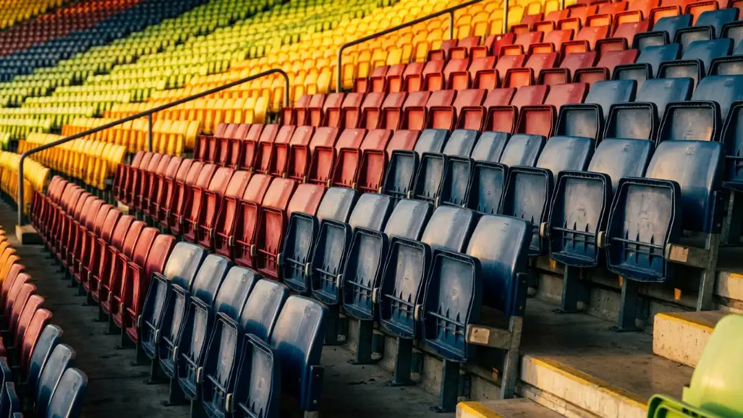 Diagonal rows of stadium seats in gradient colors